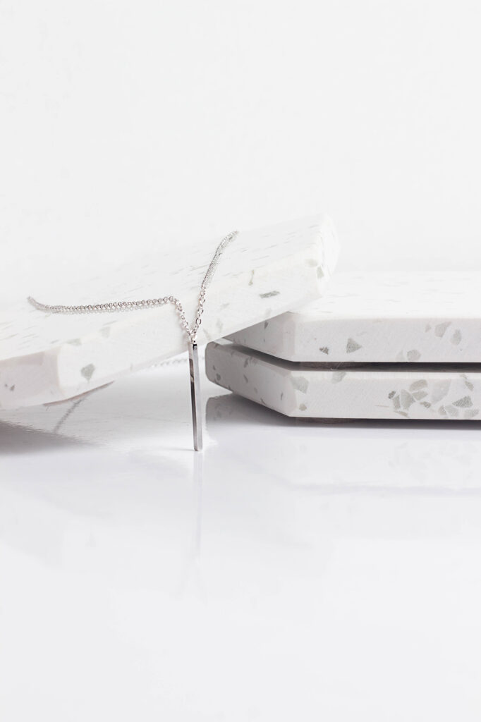 Silver necklace product photography on white background by Atlanta photographer Natalia Tamariz, showcasing elegant and high-quality jewelry for small brands.