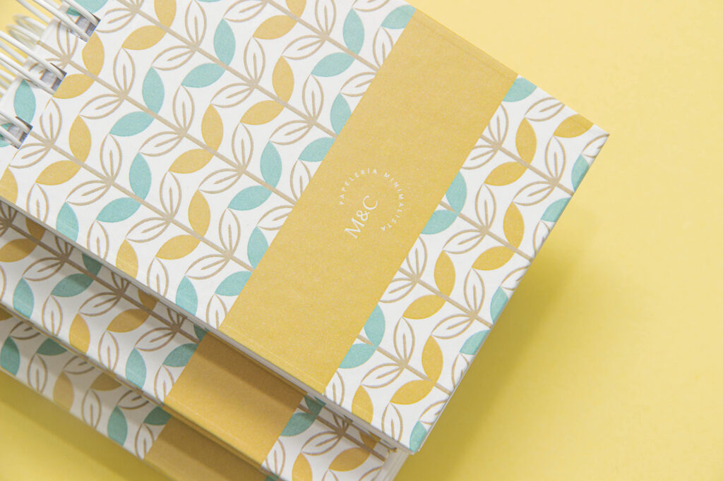 Product Photography for Minico Yellow, white, and blue notebook with leaf abstract design on yellow background, photographed by Atlanta product photographer Natalia Tamariz, highlighting stylish stationery for small brands