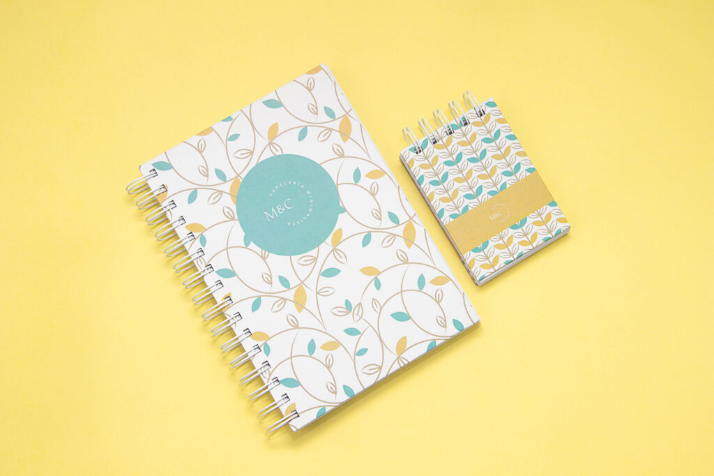 Product Photography for Minico Small notebook and notepad with yellow, white, and blue leaf abstract design on yellow background, photographed by Atlanta product photographer Natalia Tamariz, showcasing colorful stationery for small brands.
