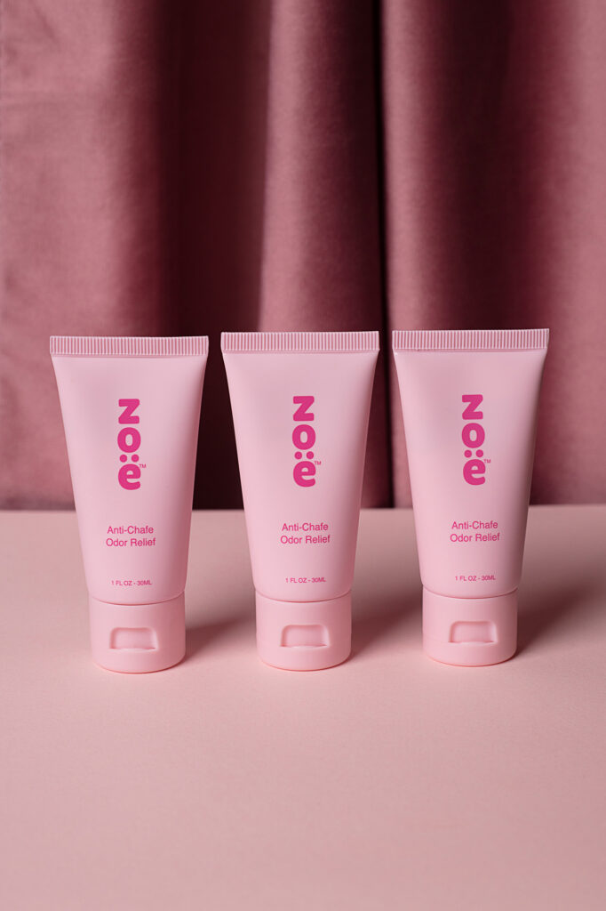 Zoe photoshoot Pink products arranged on a pink table with a darker background, photographed by Atlanta product photographer Natalia Tamariz, showcasing stylish and vibrant items for small brands.
