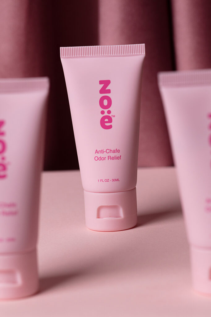 Zoe photoshoot Pink products arranged on a pink table with a darker background, photographed by Atlanta product photographer Natalia Tamariz, showcasing stylish and vibrant items for small brands.
